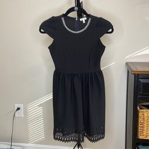 Simple black dress with decorated neck line